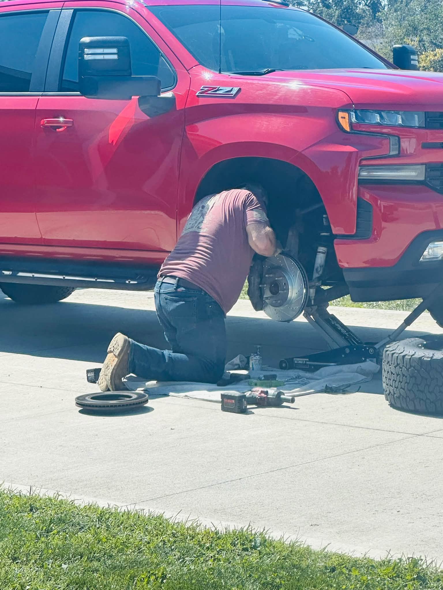 Paul repairing a red pickup truck